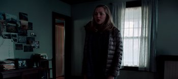 Movie still from “First Reformed” (2017), directed by Paul Schrader – A woman standing in front of a window in a room; Medium shot, Over the shoulder angle