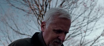 Movie still from “First Reformed” (2017), directed by Paul Schrader – An older man with white hair looking down at the ground; Close Up shot, Low angle