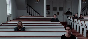 Movie still from “First Reformed” (2017), directed by Paul Schrader – A man sitting in a pew in a large church; Wide shot, High angle
