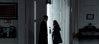 Movie still from “First Reformed” (2017), directed by Paul Schrader – A man and a woman standing in front of an open door; Medium shot, Over the shoulder angle