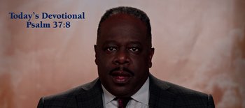 Movie still from “First Reformed” (2017), directed by Paul Schrader – A person wearing a suit and tie; Close Up shot, High angle