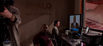 Movie still from “First Reformed” (2017), directed by Paul Schrader – A man and a woman sitting in front of a television; Wide shot, Over the shoulder angle