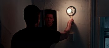 Movie still from “First Reformed” (2017), directed by Paul Schrader – A man holding a frying pan in front of a mirror; Extreme Close Up shot, High angle