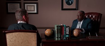 Movie still from “First Reformed” (2017), directed by Paul Schrader – A couple of books on top of a wooden table; Medium shot, Overhead angle