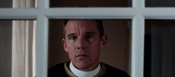 Movie still from “First Reformed” (2017), directed by Paul Schrader – A person looking at the camera; Close Up shot, Low angle