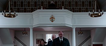 Movie still from “First Reformed” (2017), directed by Paul Schrader – A group of people walking in front of a building; Medium shot, Low angle