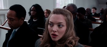 Movie still from “First Reformed” (2017), directed by Paul Schrader – A person with long brown hair; Close Up shot, Over the shoulder angle