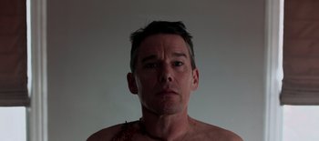 Movie still from “First Reformed” (2017), directed by Paul Schrader – A man with a chain around his neck and chest; Close Up shot, Low angle