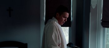 Movie still from “First Reformed” (2017), directed by Paul Schrader – A man in a white shirt with blood all over his shirt; Medium shot, Low angle