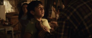 Movie still from “Flamin' Hot” (2023), directed by Eva Longoria – A young boy looking up into the sky; Medium shot, Over the shoulder angle