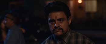 Movie still from “Flamin' Hot” (2023), directed by Eva Longoria – A person with a mustache; Close Up shot, Low angle