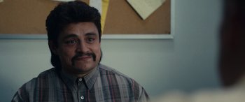 Movie still from “Flamin' Hot” (2023), directed by Eva Longoria – A person with a beard and mustache; Close Up shot, Over the shoulder angle