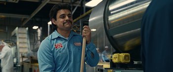 Movie still from “Flamin' Hot” (2023), directed by Eva Longoria – A man in a blue shirt holding a wooden stick; Close Up shot, Low angle