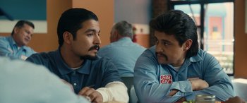 Movie still from “Flamin' Hot” (2023), directed by Eva Longoria – A couple of men sitting next to each other at a table; Close Up shot, Over the shoulder angle