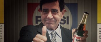 Movie still from “Flamin' Hot” (2023), directed by Eva Longoria – A person wearing a suit and tie; Extreme Close Up shot, Low angle