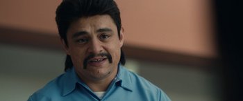 Movie still from “Flamin' Hot” (2023), directed by Eva Longoria – A person wearing a blue shirt; Close Up shot, Over the shoulder angle