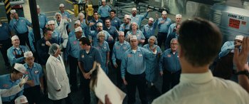 Movie still from “Flamin' Hot” (2023), directed by Eva Longoria – A group of people wearing blue shirts and hats; Wide shot, High angle