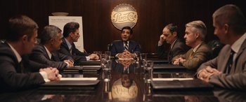 Movie still from “Flamin' Hot” (2023), directed by Eva Longoria – A group of people sitting around a table; Medium shot, Over the shoulder angle