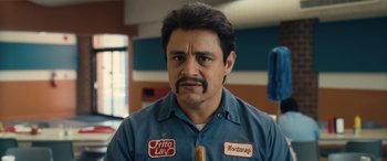 Movie still from “Flamin' Hot” (2023), directed by Eva Longoria – A man in a blue shirt with a mustache; Close Up shot, Low angle