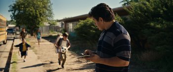 Movie still from “Flamin' Hot” (2023), directed by Eva Longoria – Two young boys playing with a soccer ball; Medium shot, Low angle