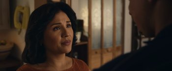 Movie still from “Flamin' Hot” (2023), directed by Eva Longoria – A person sitting in a room near a window; Close Up shot, Over the shoulder angle