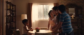 Movie still from “Flamin' Hot” (2023), directed by Eva Longoria – A group of people standing around a table; Medium shot, High angle