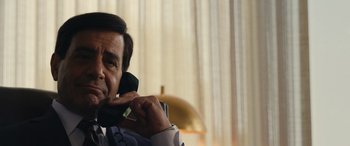 Movie still from “Flamin' Hot” (2023), directed by Eva Longoria – A person talking on a cell phone; Close Up shot, Over the shoulder angle