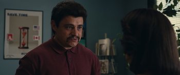 Movie still from “Flamin' Hot” (2023), directed by Eva Longoria – A person wearing a red shirt; Close Up shot, Over the shoulder angle