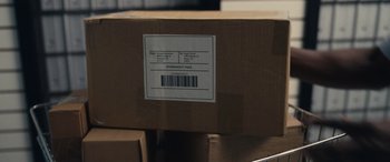 Movie still from “Flamin' Hot” (2023), directed by Eva Longoria – An image of a box that has a barcode on it; Extreme Close Up shot, High angle