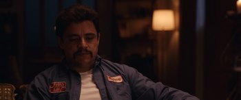 Movie still from “Flamin' Hot” (2023), directed by Eva Longoria – A person sitting down with his eyes closed; Close Up shot, Over the shoulder angle