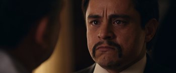 Movie still from “Flamin' Hot” (2023), directed by Eva Longoria – A person wearing a suit and mustache; Close Up shot, Low angle