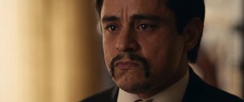 Movie still from “Flamin' Hot” (2023), directed by Eva Longoria – A person wearing a suit and tie; Close Up shot, Low angle