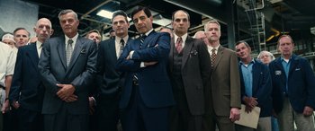 Movie still from “Flamin' Hot” (2023), directed by Eva Longoria – A group of men standing next to each other in suits; Medium shot, Low angle
