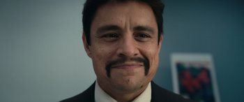 Movie still from “Flamin' Hot” (2023), directed by Eva Longoria – A person wearing a suit and tie; Extreme Close Up shot, Low angle