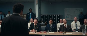 Movie still from “Flamin' Hot” (2023), directed by Eva Longoria – A group of men sitting at a table in a room; Wide shot, Over the shoulder angle