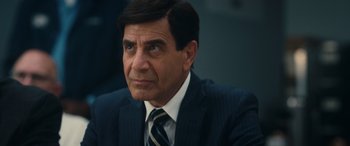 Movie still from “Flamin' Hot” (2023), directed by Eva Longoria – A person wearing a suit and tie; Close Up shot, Over the shoulder angle