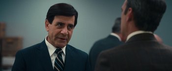 Movie still from “Flamin' Hot” (2023), directed by Eva Longoria – A man wearing a suit and tie talking to another man; Close Up shot, Over the shoulder angle