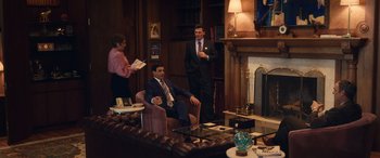 Movie still from “Flamin' Hot” (2023), directed by Eva Longoria – A group of men in suits and ties in a room; Wide shot, High angle