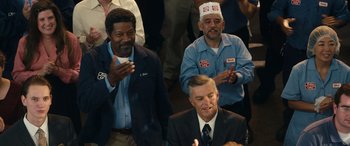Movie still from “Flamin' Hot” (2023), directed by Eva Longoria – A group of men in suits and hats clapping; Medium shot, Low angle