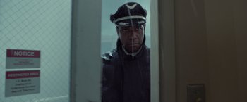 Movie still from “Flight” (2012), directed by Robert Zemeckis – A man wearing a hat looking out of a window; Close Up shot, Low angle