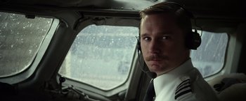 Movie still from “Flight” (2012), directed by Robert Zemeckis – A man in a helicopter looking out a window; Close Up shot, Low angle
