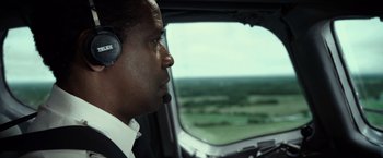 Movie still from “Flight” (2012), directed by Robert Zemeckis – A man in a helicopter looking out a window; Close Up shot, Over the shoulder angle