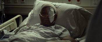 Movie still from “Flight” (2012), directed by Robert Zemeckis – A man with a bandaged head in a hospital bed; Close Up shot, High angle