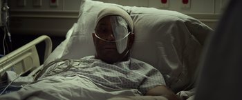 Movie still from “Flight” (2012), directed by Robert Zemeckis – A man with a bandage on his head is laying in a hospital bed; Close Up shot, High angle