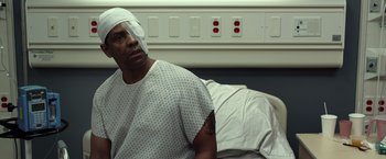 Movie still from “Flight” (2012), directed by Robert Zemeckis – A man with a bandaged head sitting on a hospital bed; Close Up shot, High angle