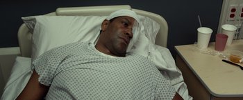 Movie still from “Flight” (2012), directed by Robert Zemeckis – A man with a bandaged head lying in a hospital bed; Close Up shot, Overhead angle