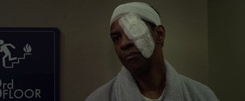 Movie still from “Flight” (2012), directed by Robert Zemeckis – A man with a bandage on his head and face; Close Up shot, High angle