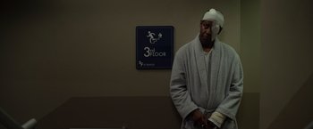 Movie still from “Flight” (2012), directed by Robert Zemeckis – A man in a bathrobe with bandages on his head; Medium shot, High angle