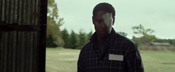 Movie still from “Flight” (2012), directed by Robert Zemeckis – A man with a bandage on his face; Close Up shot, Over the shoulder angle