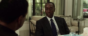Movie still from “Flight” (2012), directed by Robert Zemeckis – A man in a suit and tie sitting in front of a window; Close Up shot, Over the shoulder angle